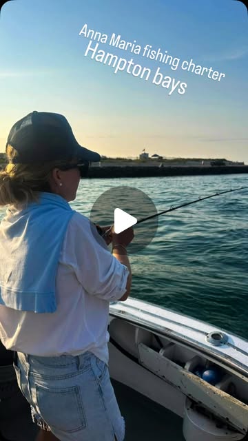 An adult woman actively fishing from the gunwale in warm evening light